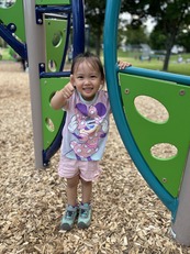 Preschool girl giving thumbs up