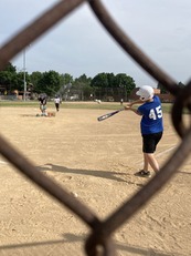 Baseball player through fence