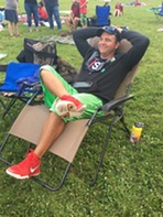 Man in lawn chair at Movie in the Parks event