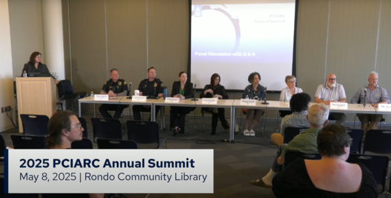 Panelists speak during the 2025 PCIARC Annual Summit at Rondo Community Library, with attendees seated and listening.