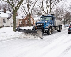 Truck plowing a snowy Saint Paul street
