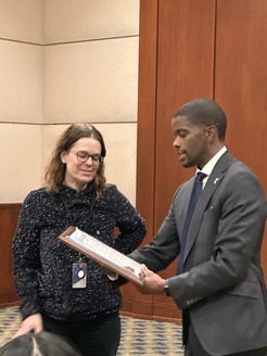 Mayor Melvin Carter presenting proclamation to Andrea Ledger. 