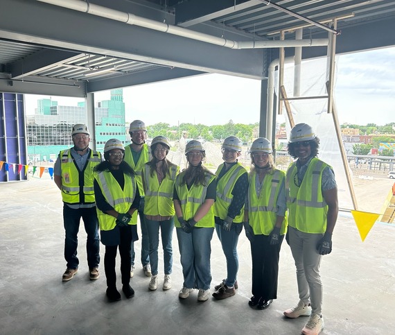 The group that toured the United Village site, standing on the third floor of the new office building.