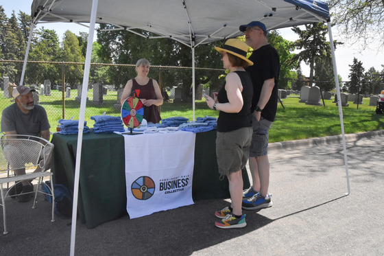 Tabling event with people talking at Como, Front, Dale corridor