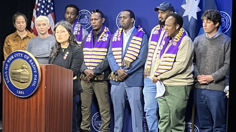 Pictured: Council Member Kim speaks alongside Council President Noecker and rideshare drivers.