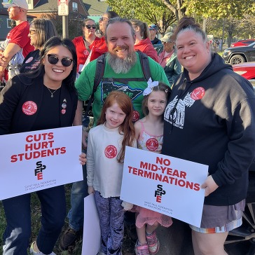 SPFE Rally with Signs Reading No Cuts to Teachers