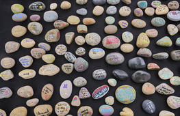 small rocks painted with names of enslaved people buried in the cemetery