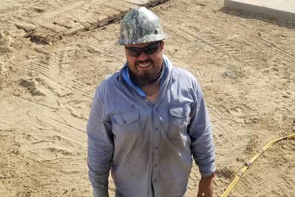 Industrial radiographer Steven Serrano standing near a pipeline transfer station in Katy.