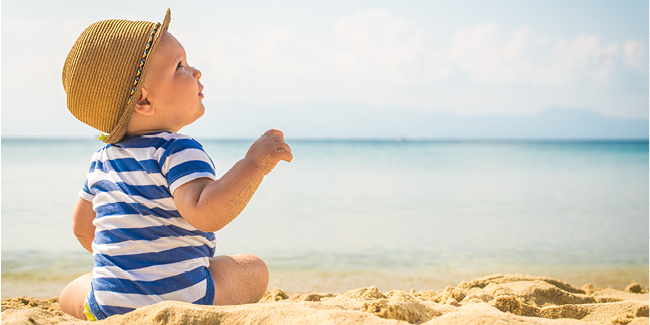 Baby sitting on the beach