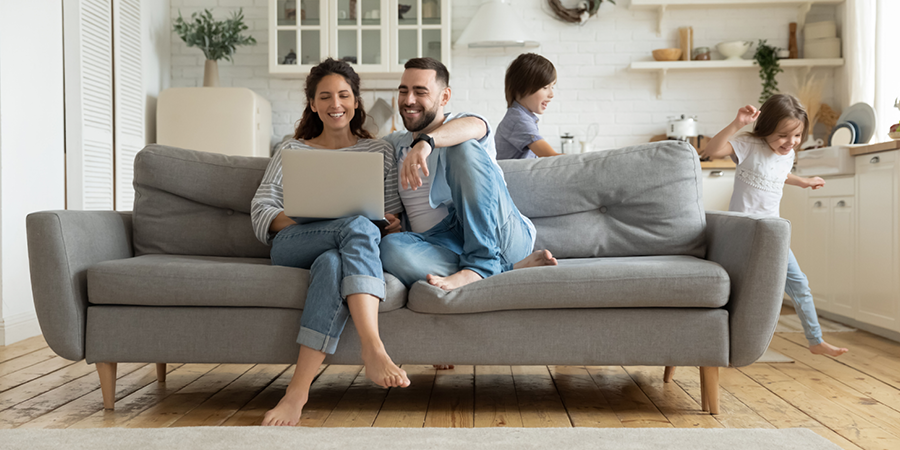 Planning ahead Mother and father plan the financial future of their two children, who are running through the room.