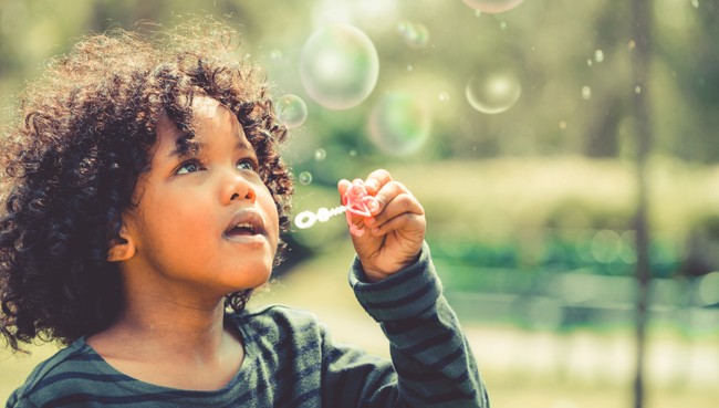 girl blowing bubbles