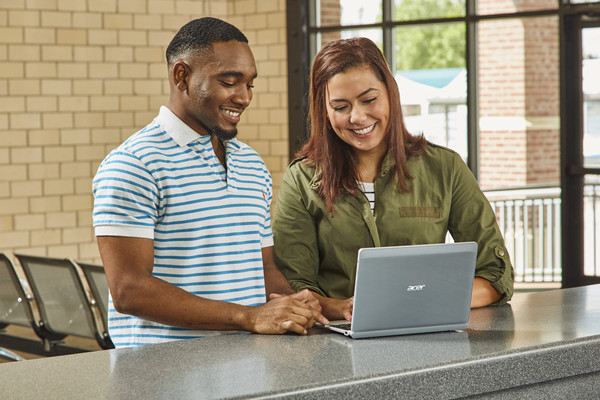 Man and woman looking at computer