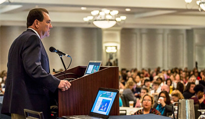 Whitman speaking at conference