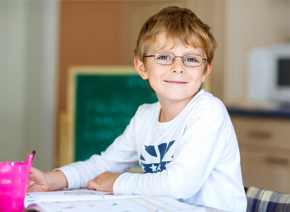 Happy boy working on school work