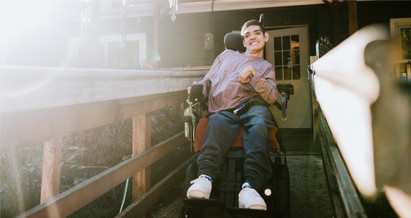 APS client image -- a man in a wheelchair leave his home 