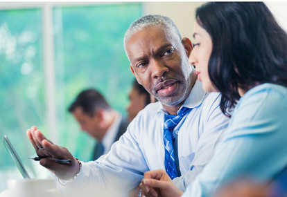 APS mentor giving advice to newly-hired staff member.