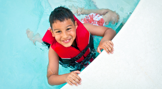 Kid in pool with lifejacket