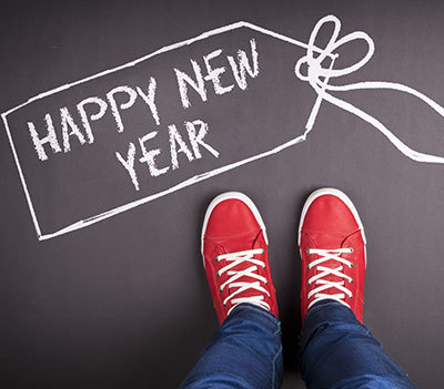 red shoes next to text Happy New Year writtin in chalk