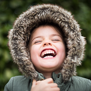 child in winter big smile laughing