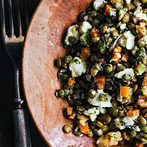 French lentil salad on a wood plate