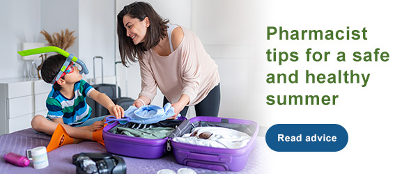 woman packing suitcase with son wearing snorkel