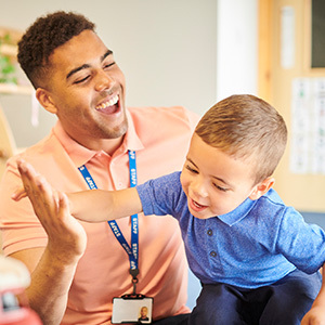teacher with child in daycare