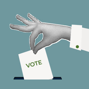 Hand placing vote in ballot box