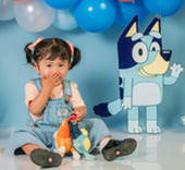 Young girl at a party with Bluey-themed decoration