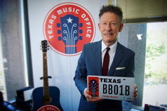 Lyle Lovett with Texas Music charitable license plate