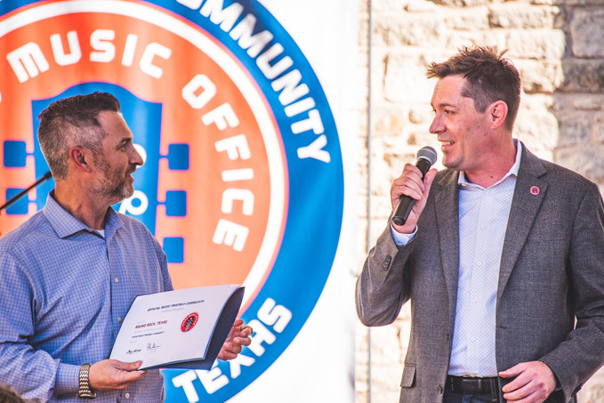Round Rock's Mayor Craig Morgan accepts the Music Friendly Community certification from TMO's Chip Adams