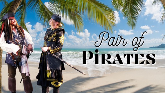 Two pirates standing in front of a beach area