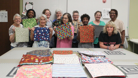 senior center members making mats for meels on wheels