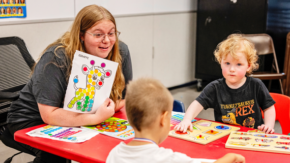 Instructor at the Hurst Recreation Center teaching an art class of children