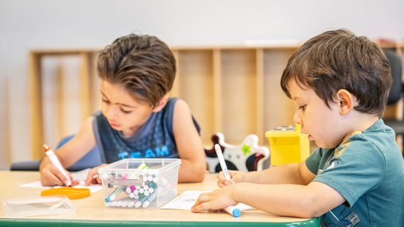Two boys coloring at the Hurst Recreation Center