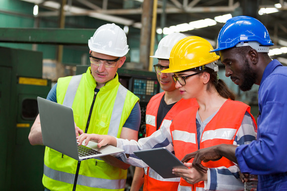 Warehouse workers reviewing training procedures