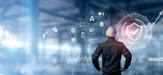 A man wearing a hard hat scans safety icons floating on a graphic user interface.