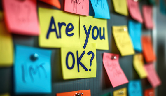 Sticky notes on a chalkboard read, "Are you OK?"