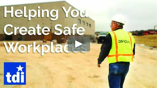 An OSHCON consultant in a reflective vest walking at an outdoor worksite.