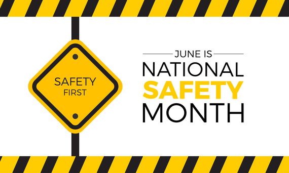 A road sign reads, "SAFETY FIRST" beside the banner, "June is NATIONAL SAFETY MONTH."