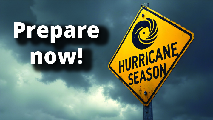 "Prepare now!" written beside a HURRICANE SEASON road sign.