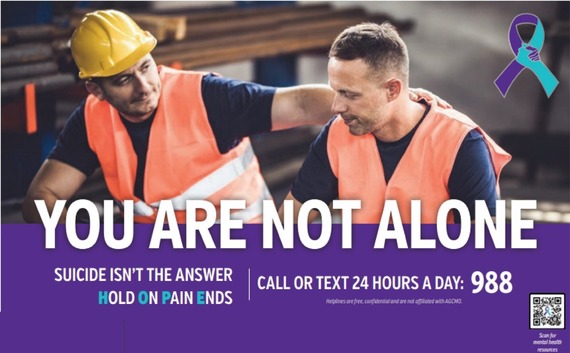 Word "You Are Not Alone" appear under two construction workers who are talking.