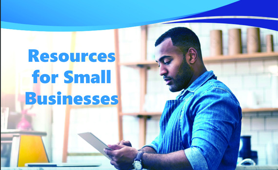 A man looks at a piece of paper with the words "Resources for Small Businesses" beside him.