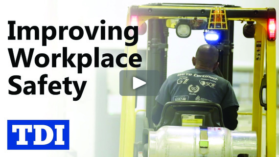 Man on a forklift beside the words, "Improving Workplace Safety."