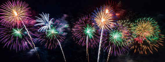 Fireworks exploding on a night sky.