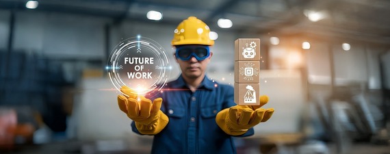 A man in gloves, goggles, and a hard hat holding building blocks and a hologram with icons representing AI and the future of work.