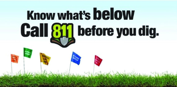 "Know what's below. Call 811 before you dig." is above flags in grass marking underground utilities.