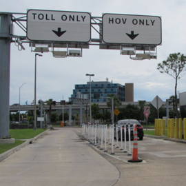 Two road signs one reads: Toll Only and the other reads: HOV Only