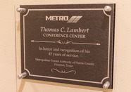 Plaque outside new conference room named in Tom Lambert's honor