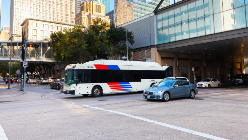 METRO CNG Bus Rides Down A Downtown Street