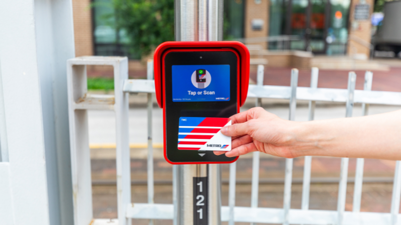 Person Holds RideMETRO Card Up to Fare Validator
